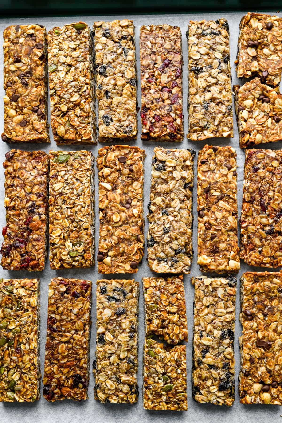 overhead view of 4 flavors of granola bars on a sheet pan.