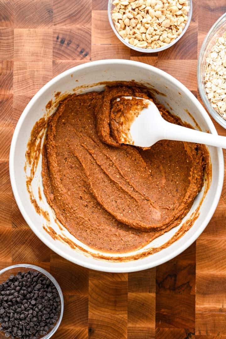 Date pate, nut butter, vanilla, honey and salt mixed together in a bowl.