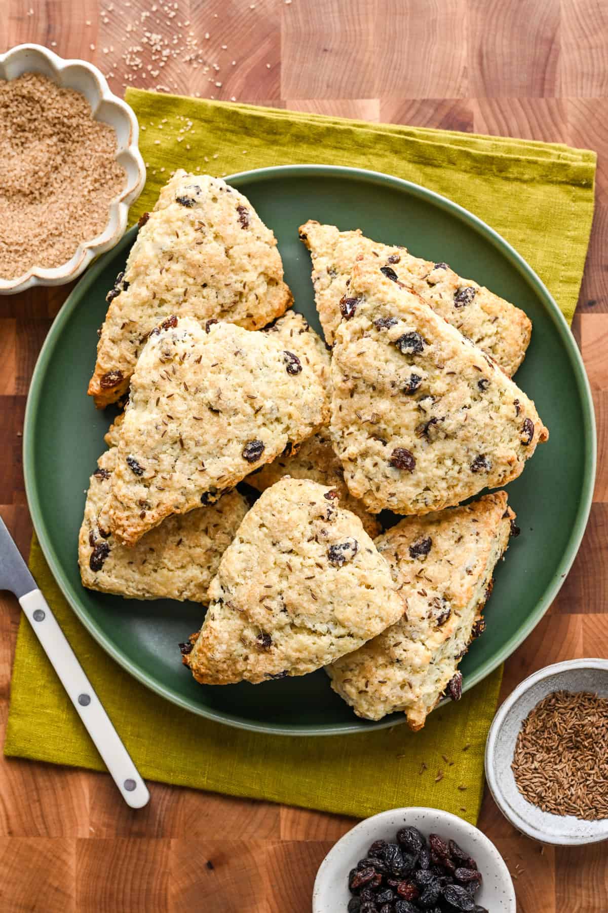 Overhead view of irish soda bread scones on a green plate.