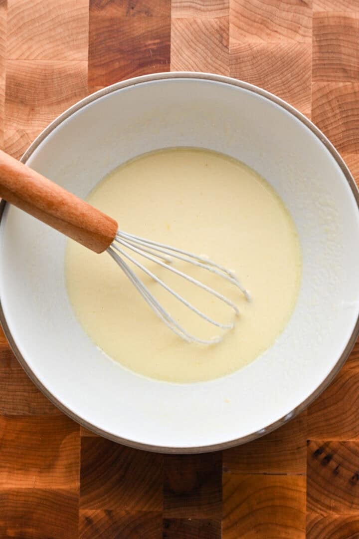 buttermilk and egg whisked together in a white mixing bowl.
