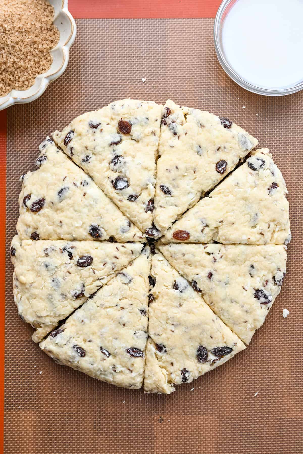 Irish soda bread scone dough formed into a circle and cut into 8 triangles.
