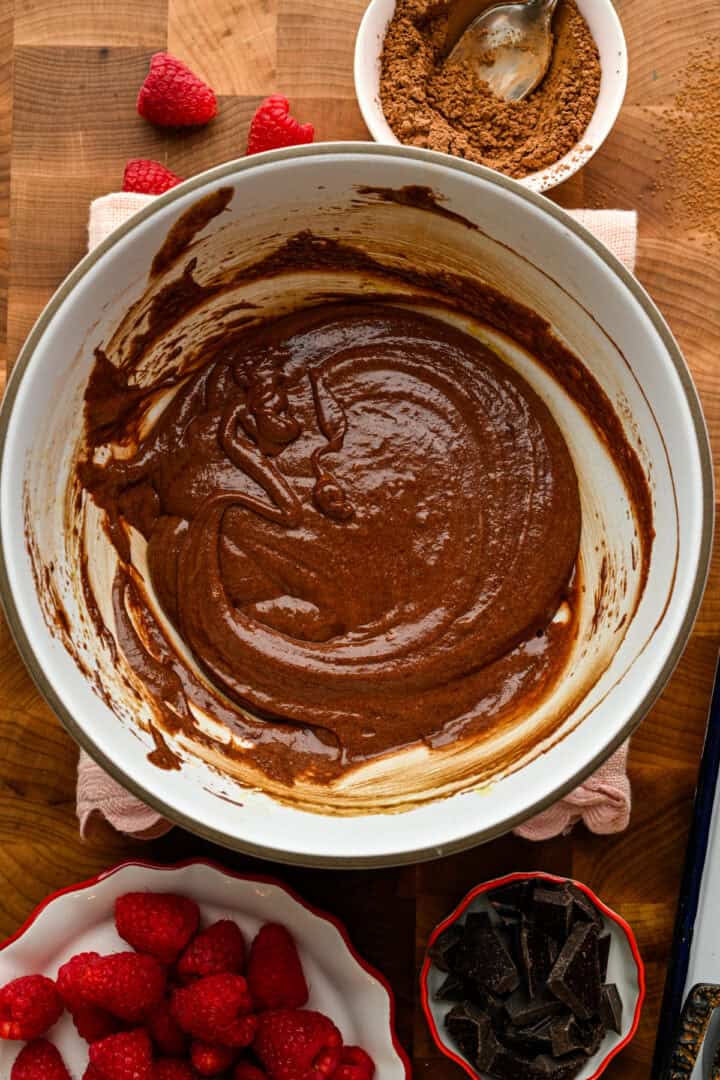 Chocolate lava cake batter in a white bowl.