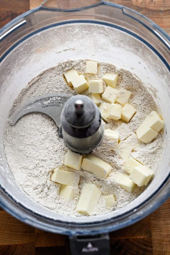 Overhead view of dough in food processor before processing.