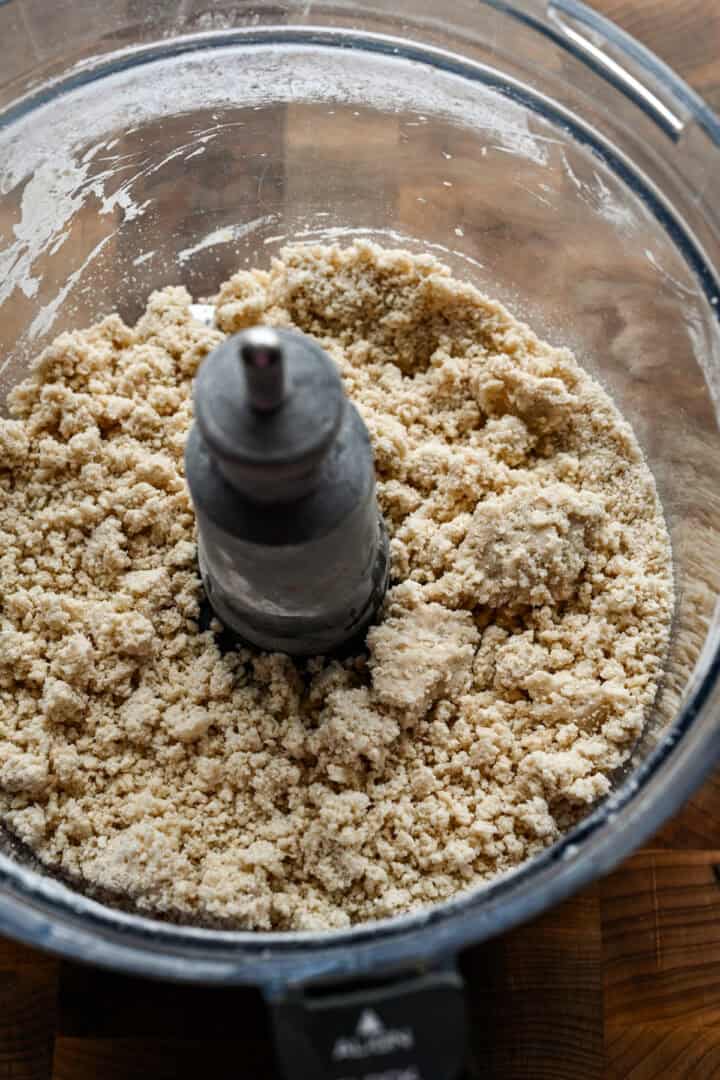 Overhead view of dough in food processor after mixing.