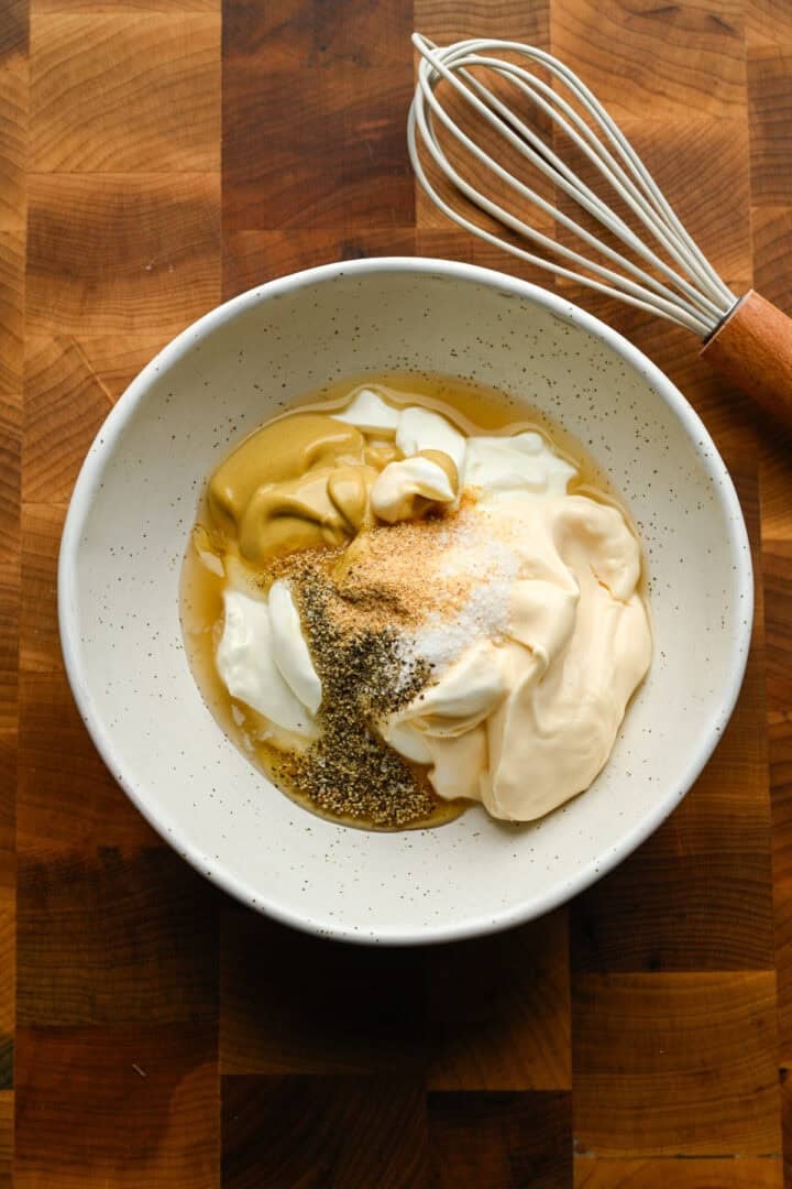 Chicken salad dressing ingredients in a bowl before mixing together.