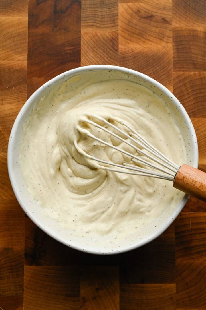 Chicken salad dressing ingredients in a bowl after mixing together.