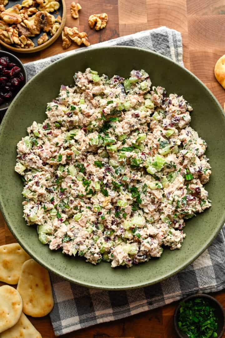 Cranberry walnut chicken salad in a green mixing bowl.