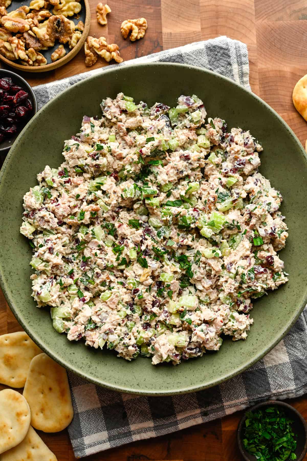 Cranberry walnut chicken salad in a green mixing bowl. 
