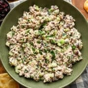 Cranberry walnut chicken salad in a green mixing bowl.