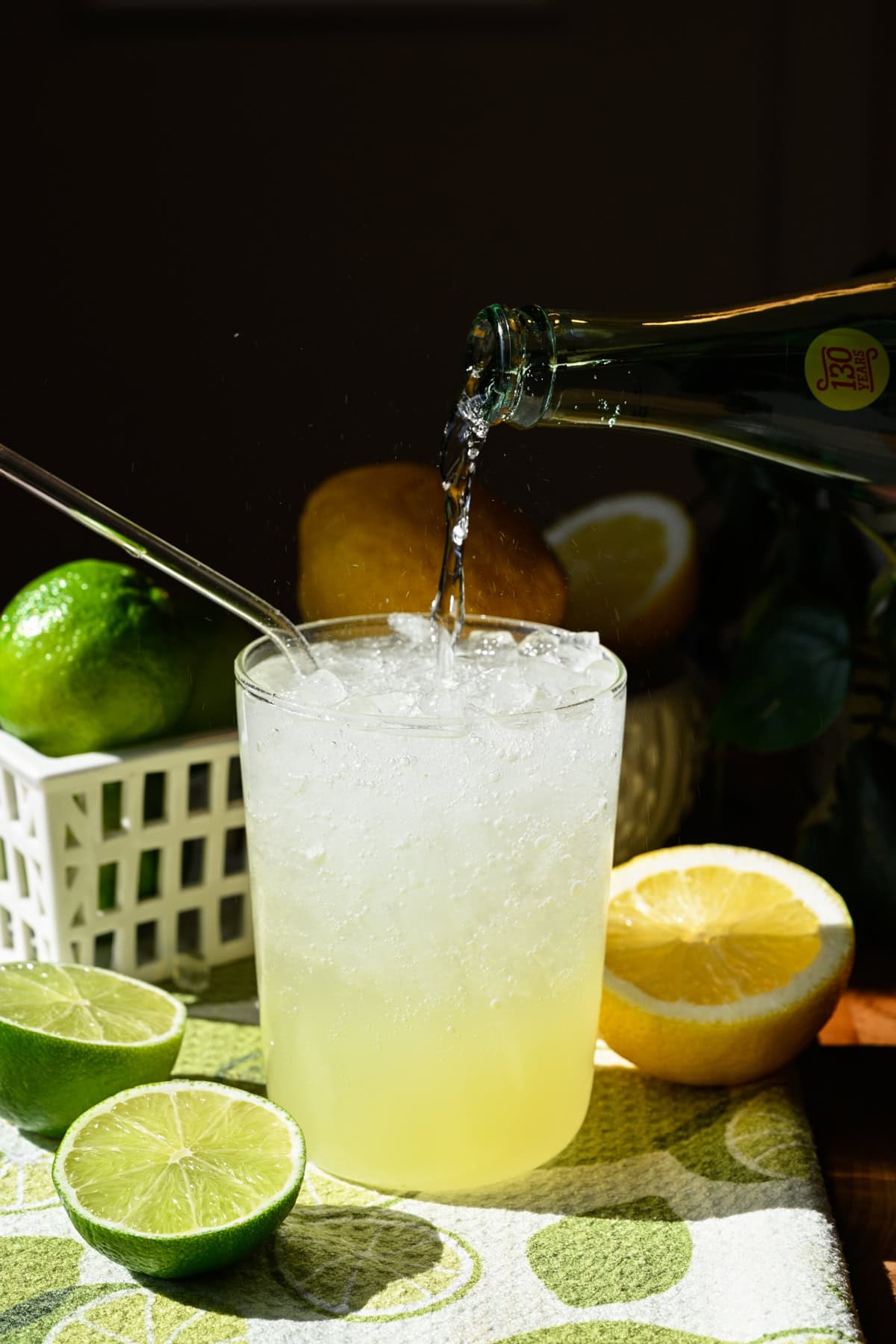 Pouring sparkling water into a glass.