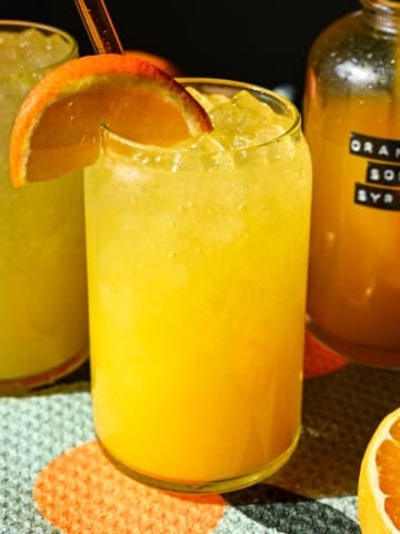 Front view of orange soda in a glass.