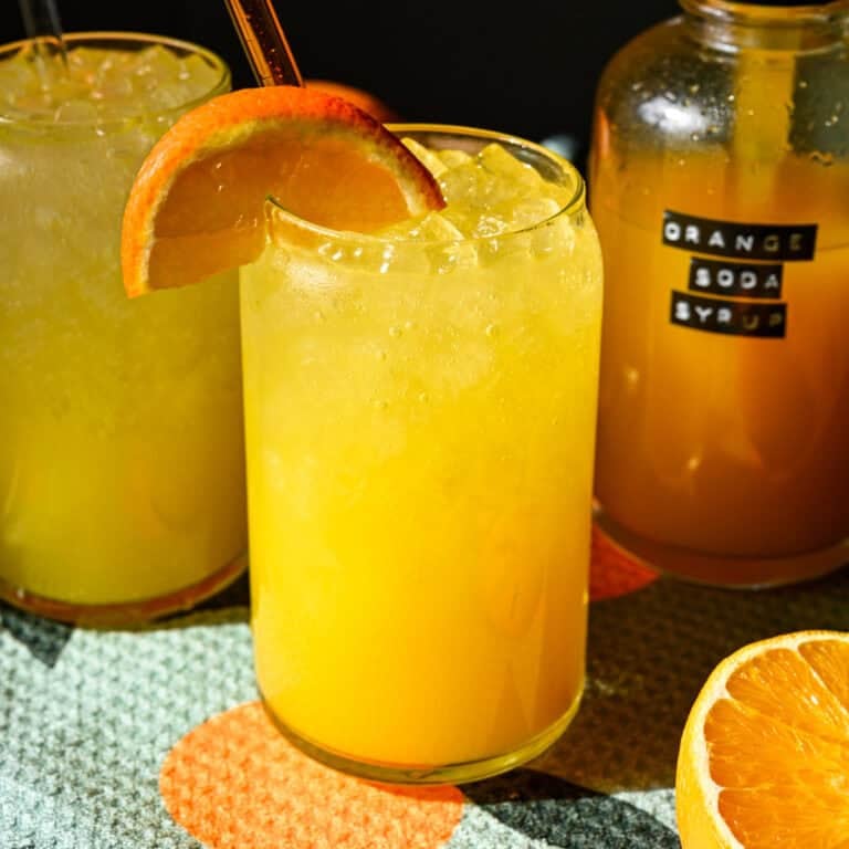 Front view of orange soda in a glass.
