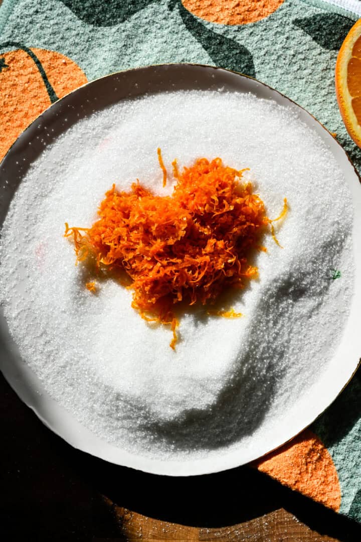 Orange zest and sugar on a plate.
