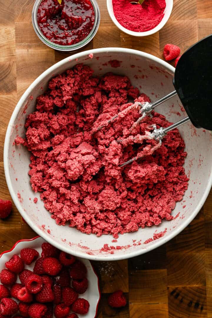 Raspberry thumbprint cookie dough in a bowl.