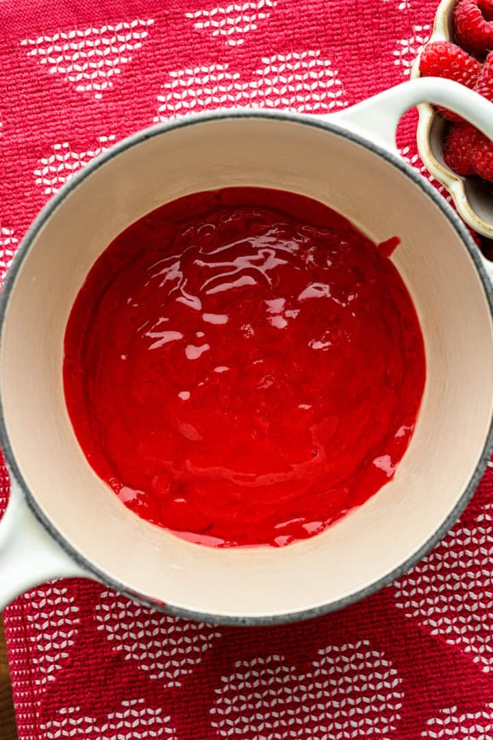 Raspberry puree in a saucepan.