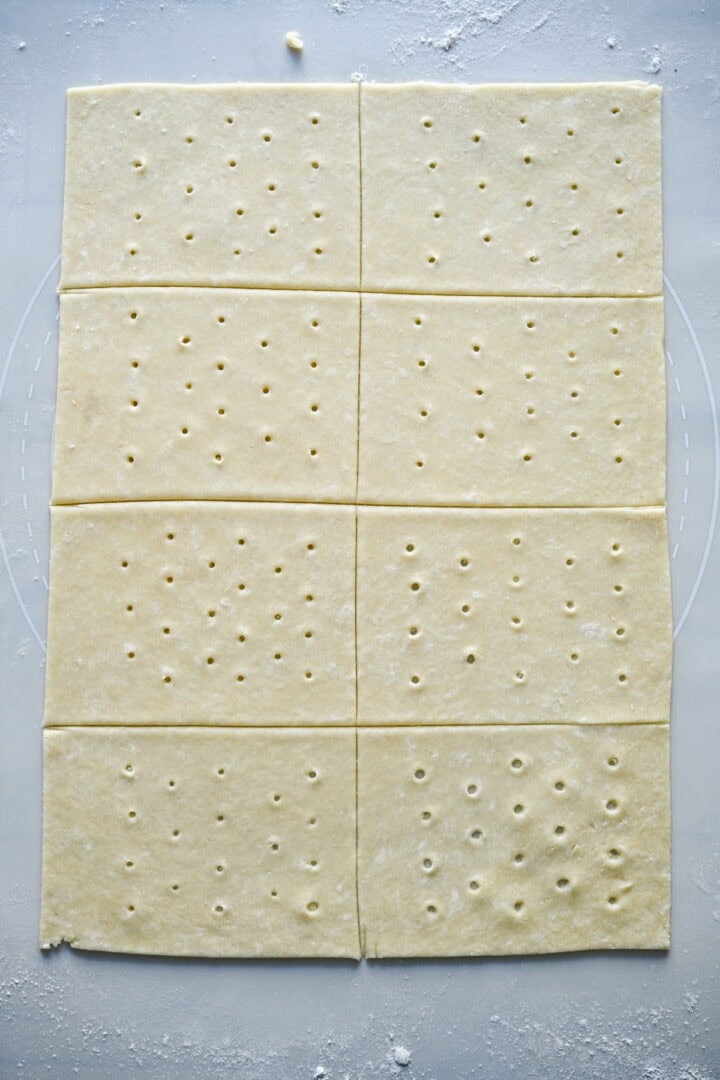8 rectangles of pop tart dough with holes poked in the center.