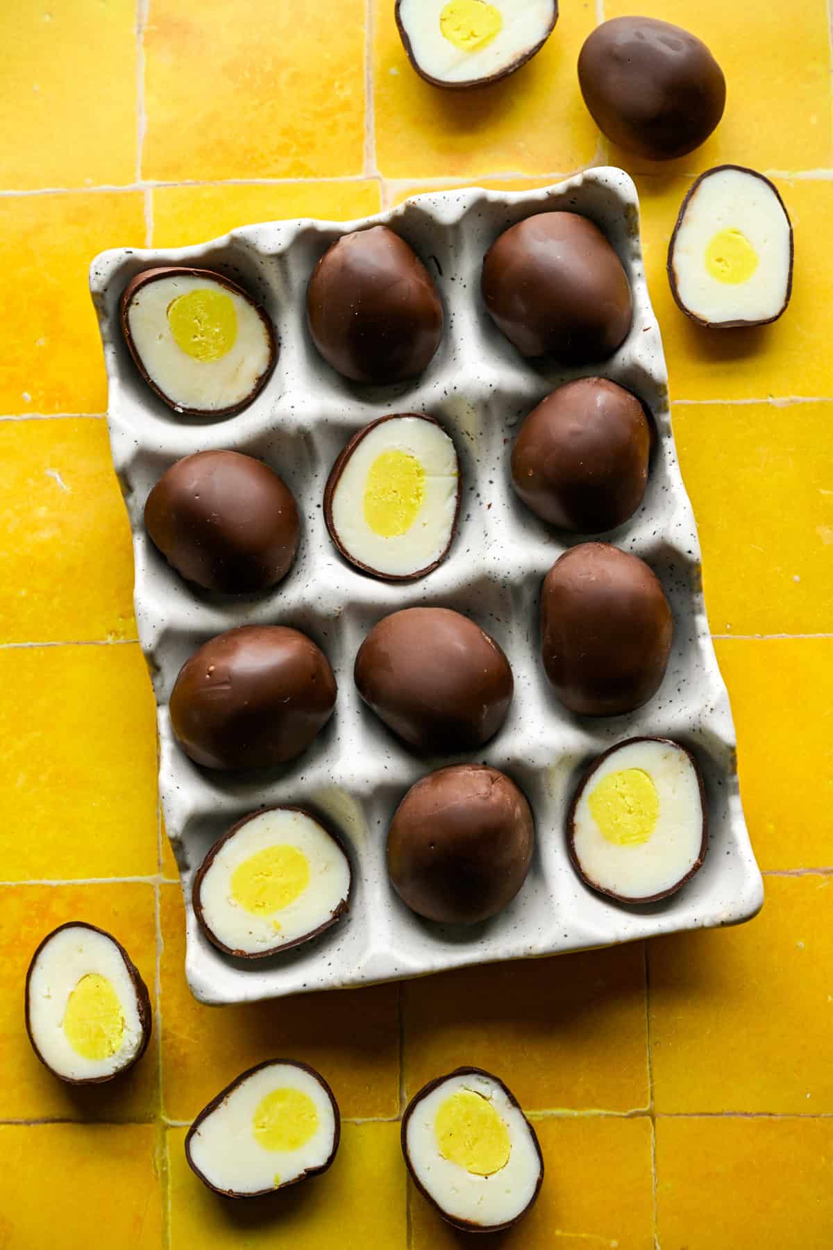 Overhead view of chocolate egg truffles in an egg container.