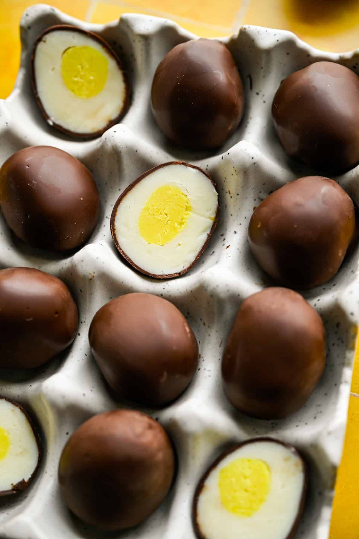 Overhead view of chocolate egg truffles in an egg container.
