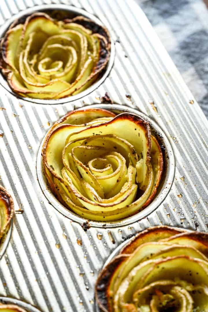 Overhead view of potato roses in a muffin tin.