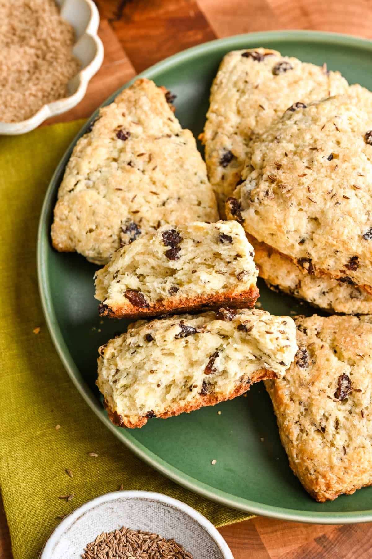 Irish soda bread scone broken in half to show interior on a green plate.