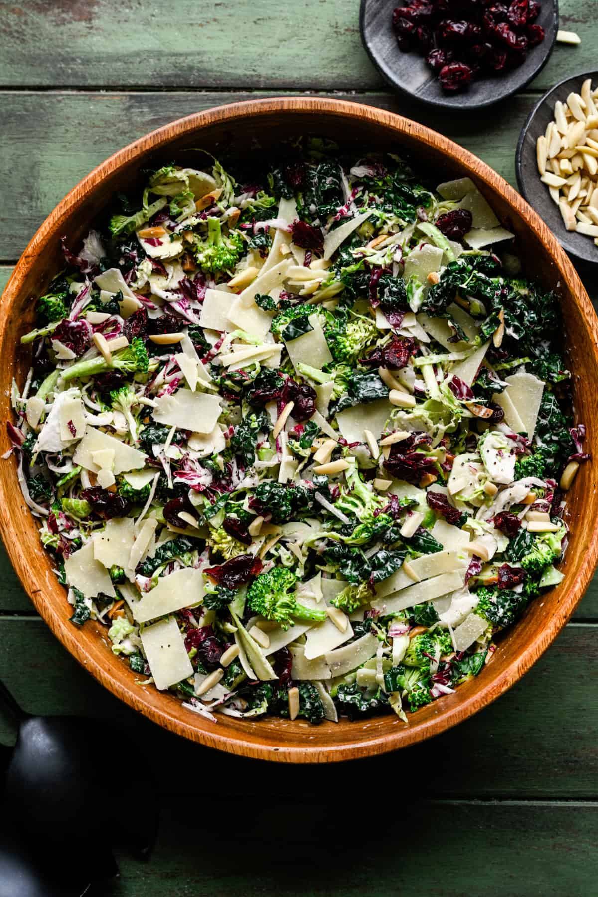 Kale Broccoli Salad with homemade poppyseed dressing fully assembled in a brown bowl.