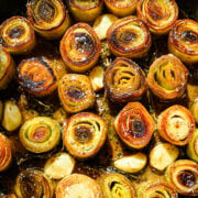 Overhead view of cooked leeks in a pan.