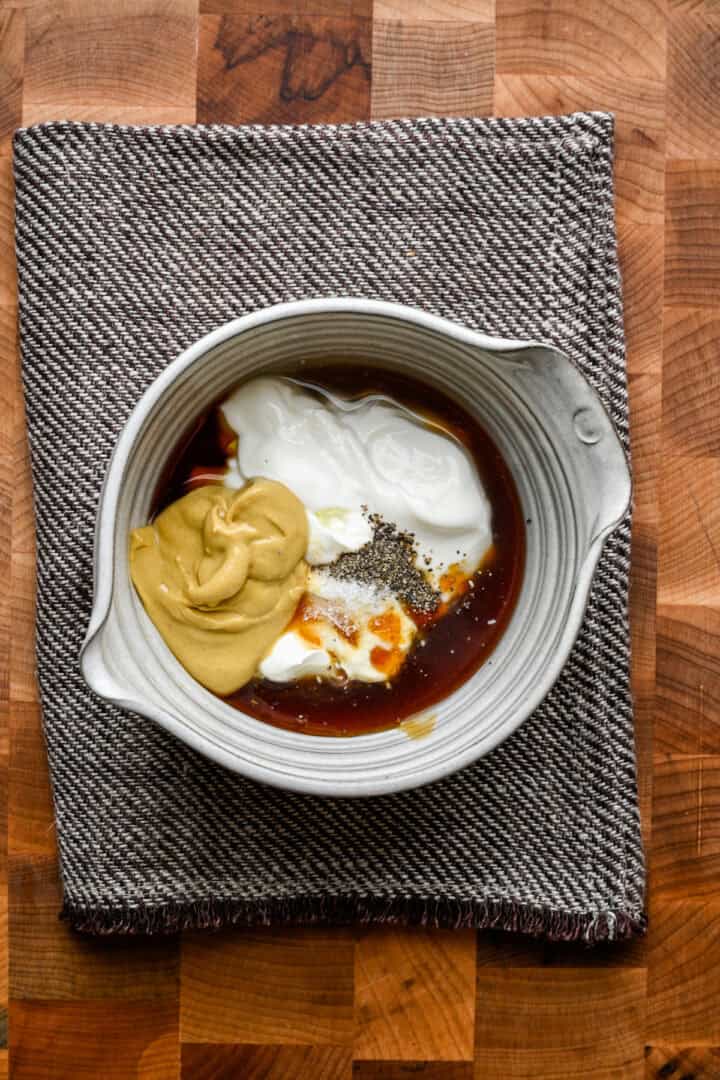 Honey mustard in a bowl before being whisked together.
