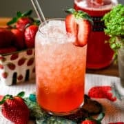 Front view of strawberry vanilla soda on a green coaster.