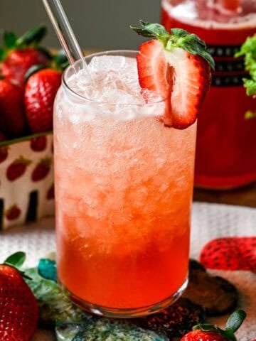 Front view of strawberry vanilla soda on a green coaster.