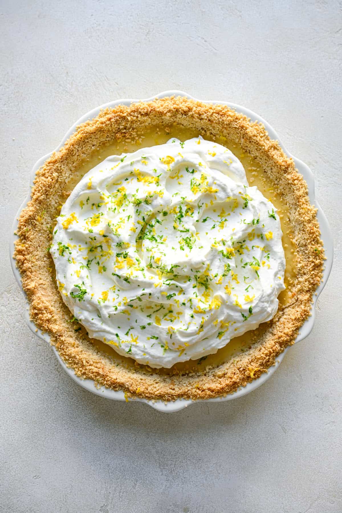 Overhead view of Atlantic Beach Pie topped with whipped cream and citrus zest.