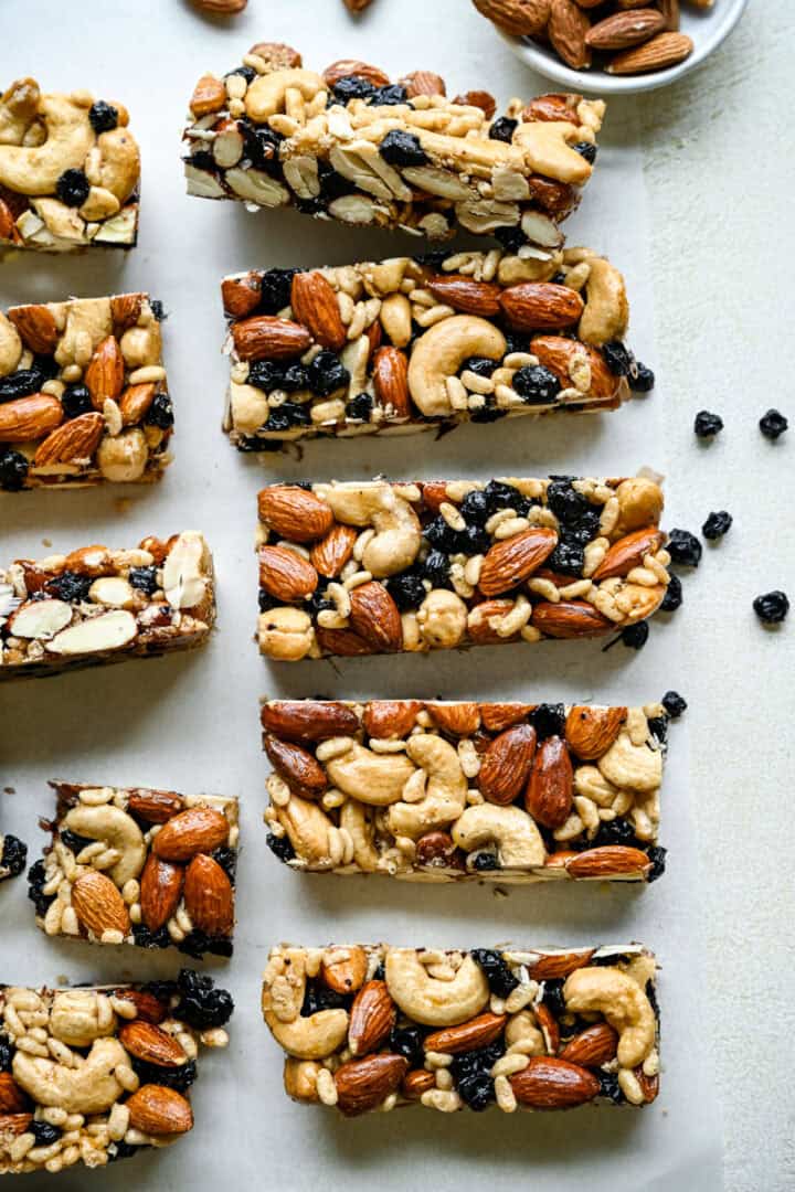 Overhead view of blueberry cashew KIND bar copycats on parchment paper.