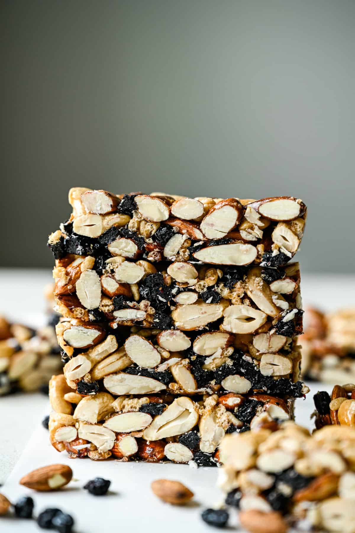 Side view of a stack of blueberry cashew KIND bar copycats with white backdrop.