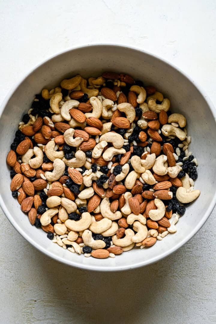 Cashews, almonds, dried blueberries and puffed rice cereal in a bowl after mixing together.