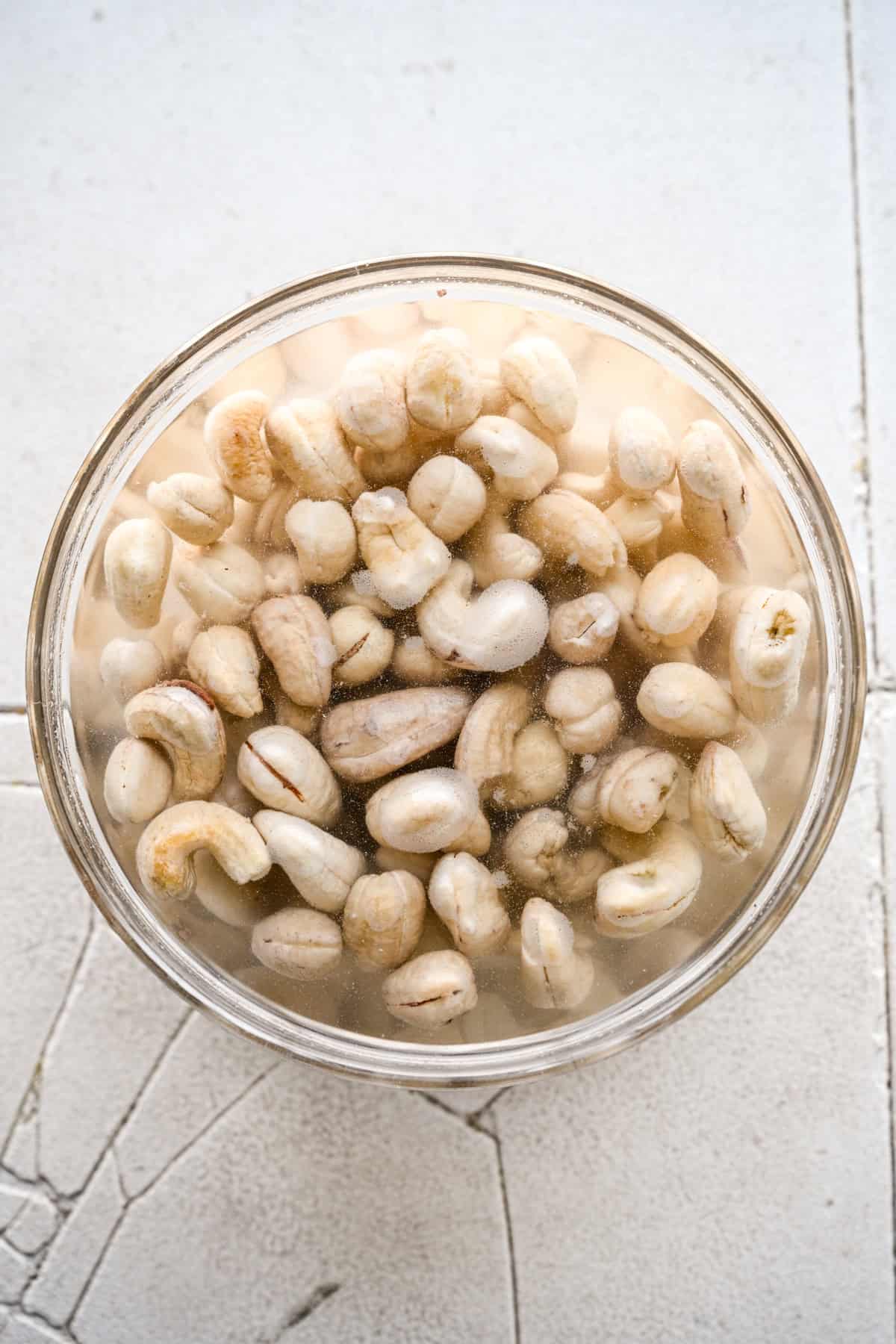 Cashews soaking in a bowl with water.