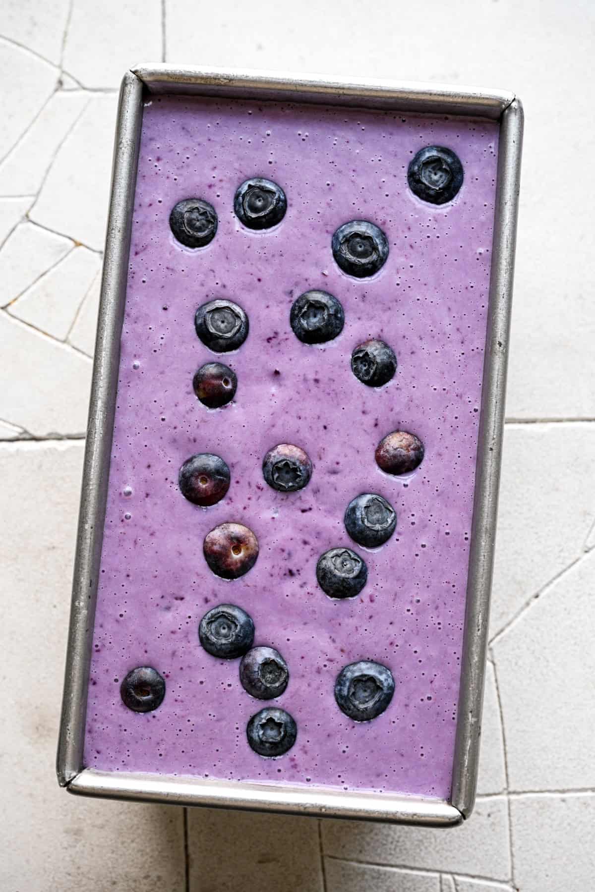 Blueberry lemon ice cream in a loaf pan before freezing.