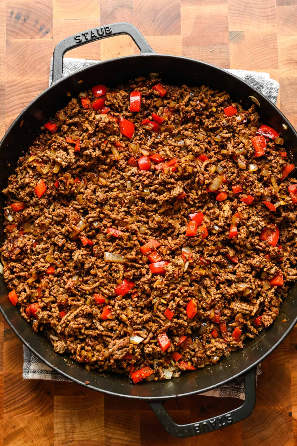 Onions and red pepper added to the skillet with the beef.