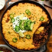 Chili pie with cornbread topping in a large skillet.