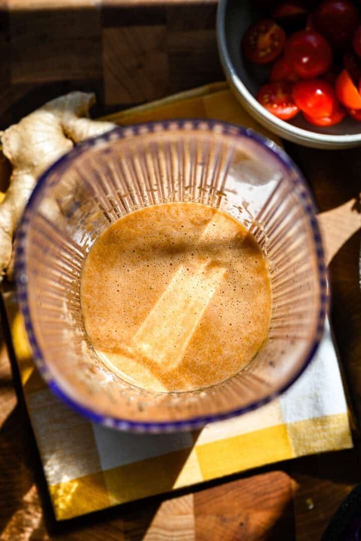 overhead view of ginger dressing in a blender after blending.