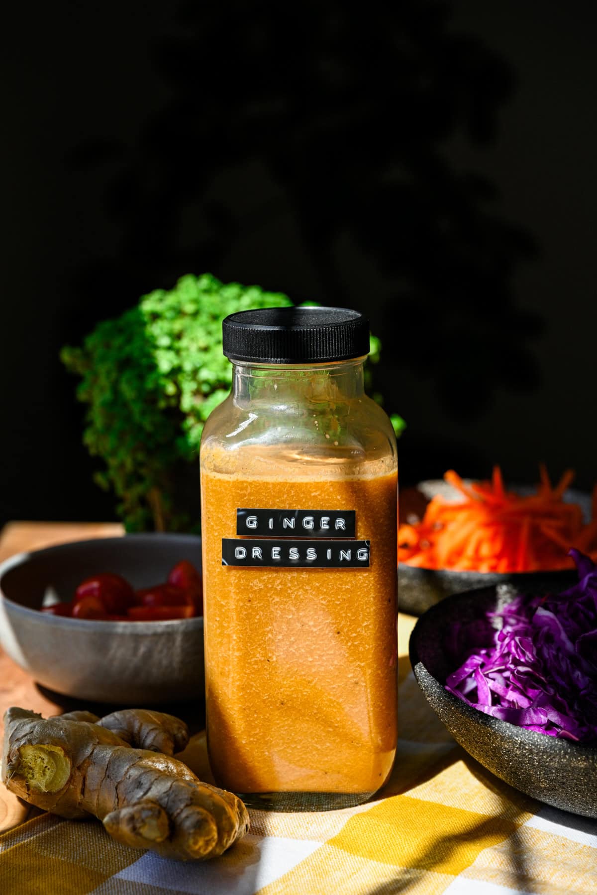 Side view of a bottle of homemade ginger dressing with a label on the bottle. 