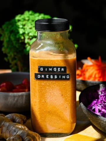 Side view of a bottle of homemade ginger dressing with a label on the bottle.