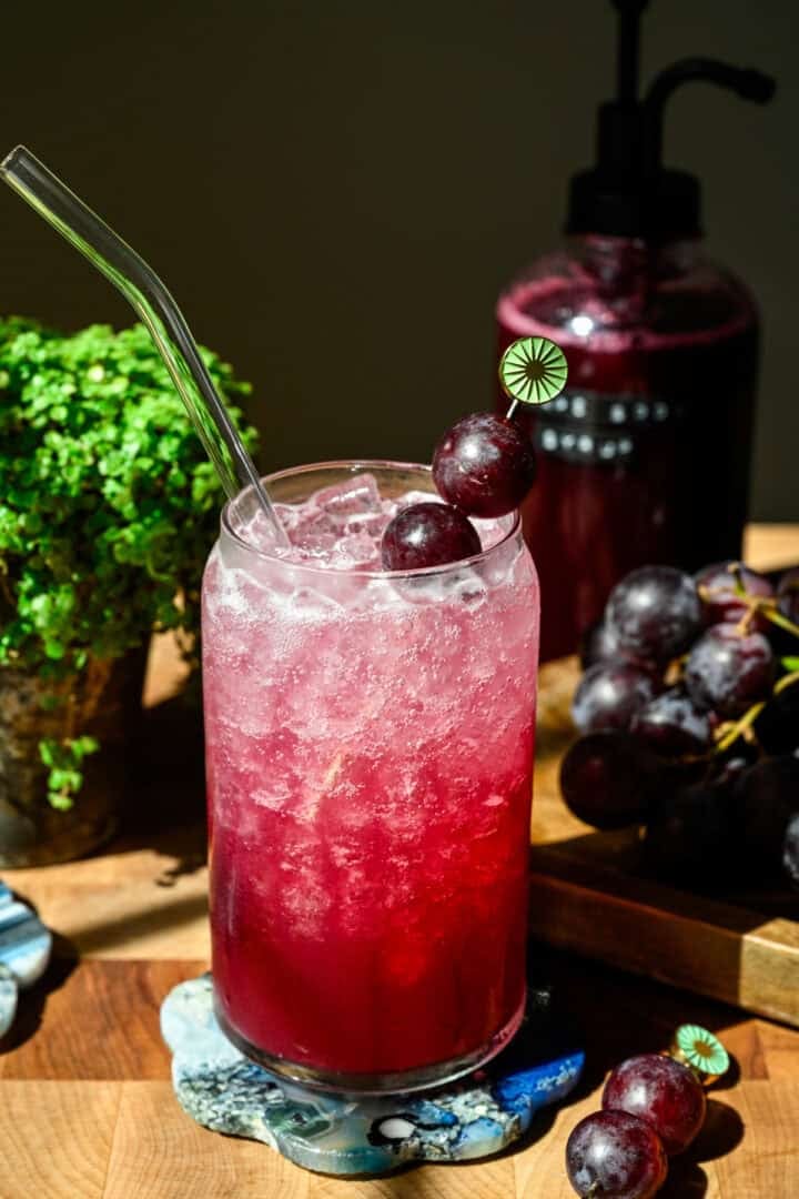 Front view of grape soda in a glass.