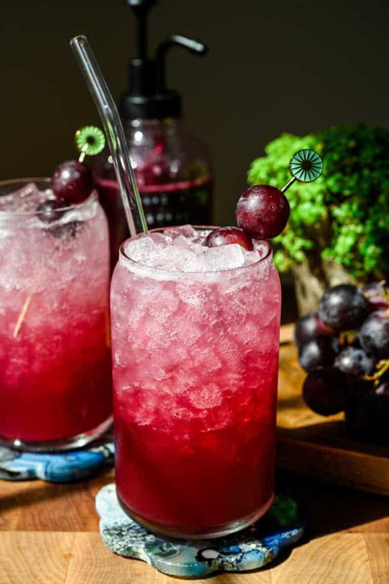 Front view of grape soda in a glass.