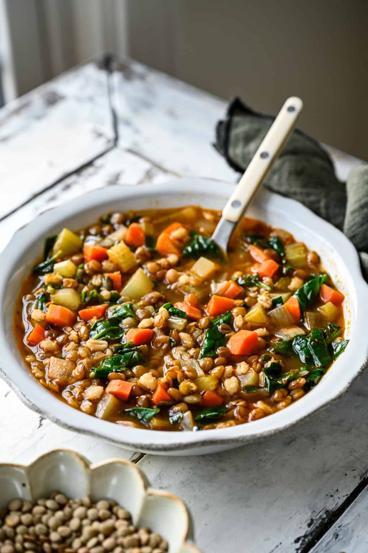 Lentil Barley soup in a white bowl.