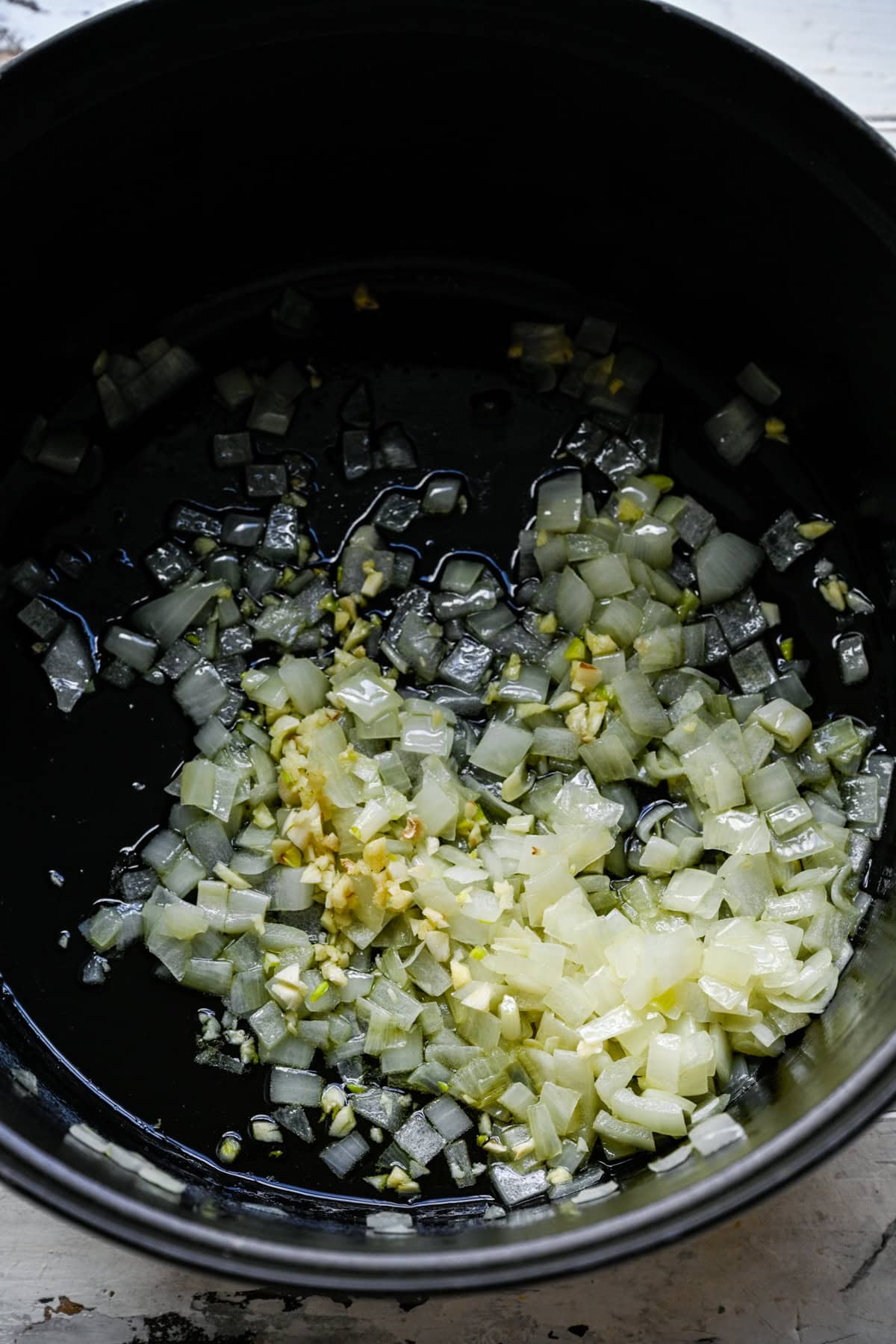 Onions and garlic cooking in a large pot.