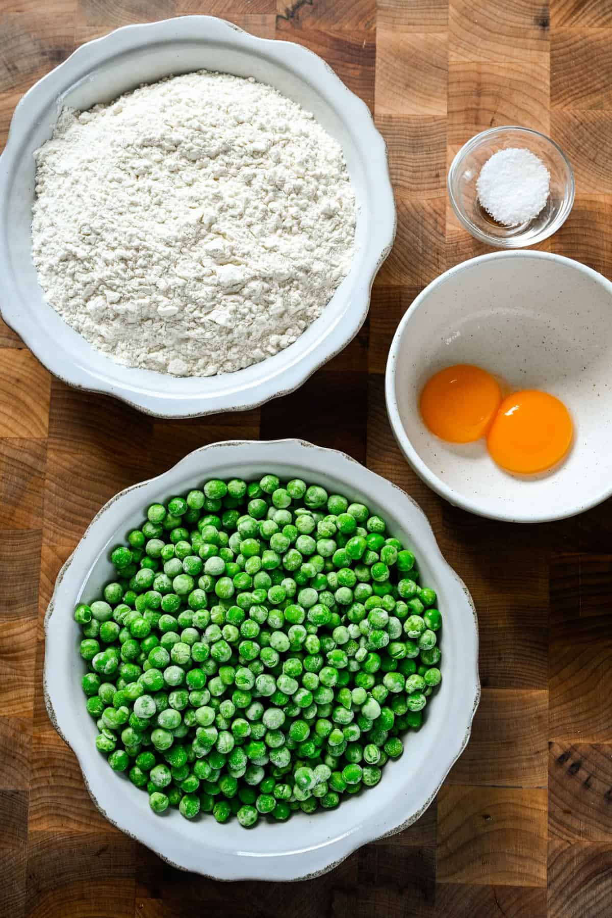 Overhead view of pea gnocchi ingredients including peas and flour.