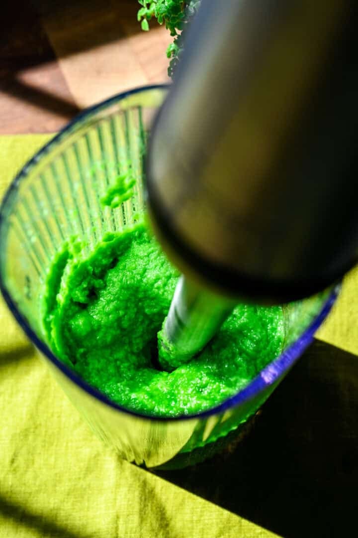 Overhead view of peas being blended.