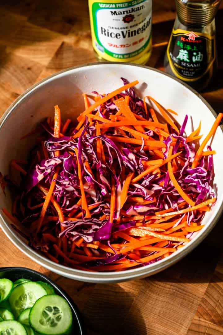 Overhead view of carrot and cabbage in a bowl.
