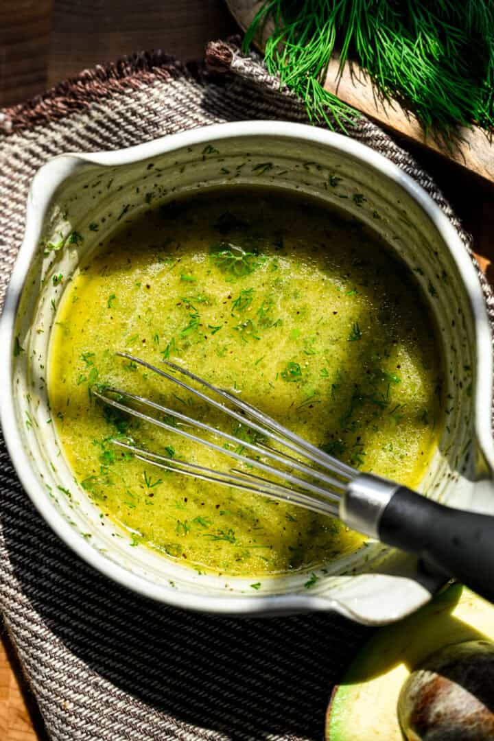 Lemon dill dressing ingredients in a bowl after whisking together.