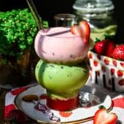 Iced strawberry matcha latte topped with strawberry cold foam.