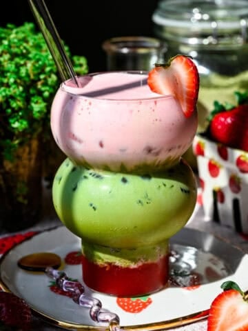 Iced strawberry matcha latte topped with strawberry cold foam.